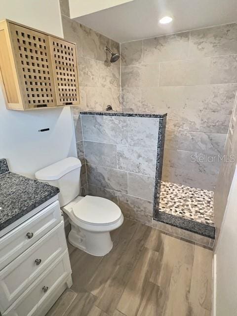 520 Jupiter Blvd NW, Palm Bay, FL 32907 - bathroom with a walk in shower, vanity, wood finished floors, and recessed lighting