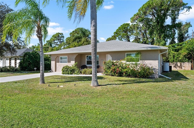 874 Acadia Rd, Venice, FL 34293 - ranch-style home with stucco siding, a front yard, and driveway
