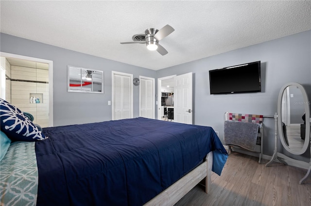 874 Acadia Rd, Venice, FL 34293 - bedroom with wood finished floors, a ceiling fan, and a textured ceiling