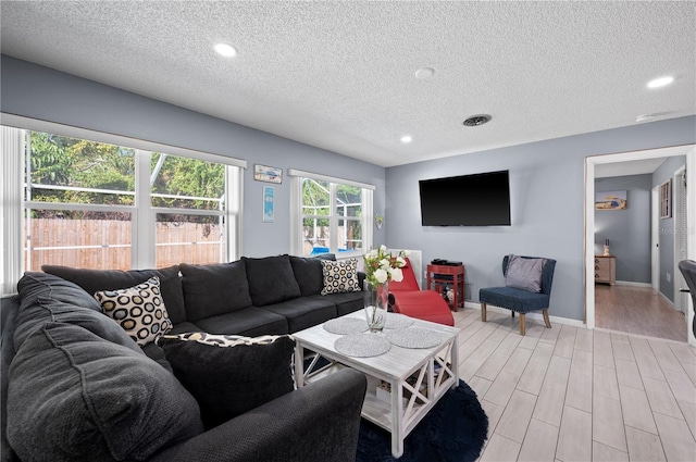 874 Acadia Rd, Venice, FL 34293 - living area with light wood-style flooring, a textured ceiling, and recessed lighting
