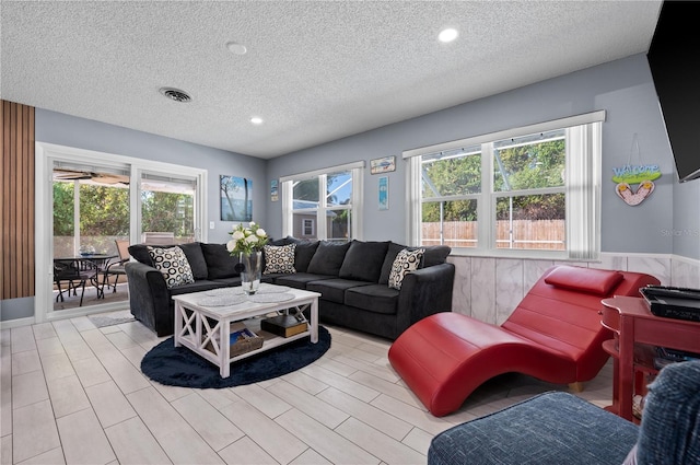 874 Acadia Rd, Venice, FL 34293 - living room with a textured ceiling, recessed lighting, and wainscoting