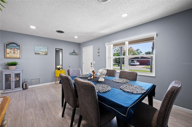 874 Acadia Rd, Venice, FL 34293 - dining area featuring a textured ceiling, light wood-style floors, and recessed lighting