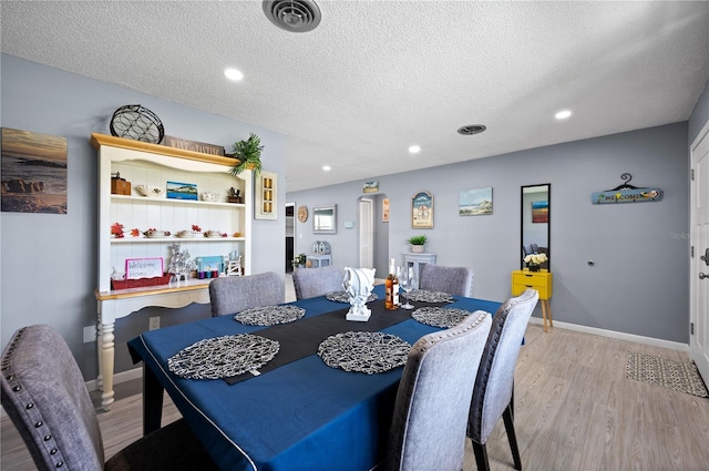 874 Acadia Rd, Venice, FL 34293 - dining space with light wood-style floors, a textured ceiling, and recessed lighting