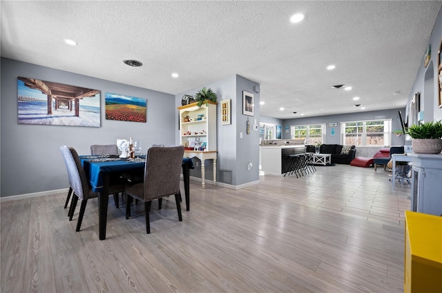 874 Acadia Rd, Venice, FL 34293 - dining room with a textured ceiling, light wood finished floors, and recessed lighting