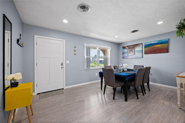 874 Acadia Rd, Venice, FL 34293 - dining space with light wood finished floors, a textured ceiling, and recessed lighting