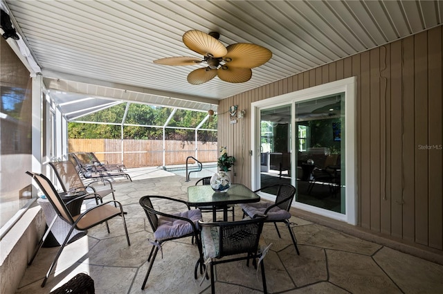 874 Acadia Rd, Venice, FL 34293 - view of patio / terrace with a ceiling fan, glass enclosure, and outdoor dining space