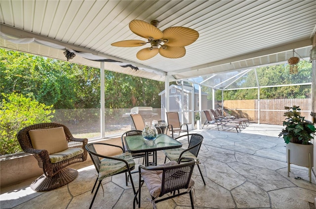 874 Acadia Rd, Venice, FL 34293 - fenced backyard with a storage shed, outdoor dining space, a patio area, glass enclosure, and ceiling fan
