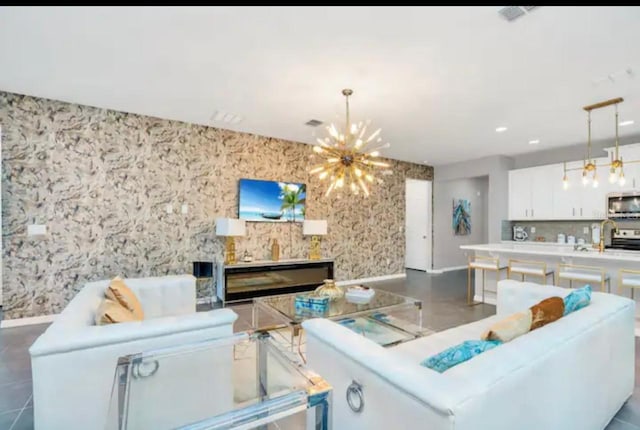 1870 Sawyer Palm Pl Unit 1870, Kissimmee, FL 34747 - living area featuring a chandelier, a fireplace, and wallpapered walls