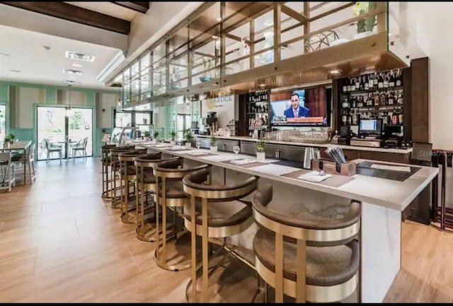 1870 Sawyer Palm Pl Unit 1870, Kissimmee, FL 34747 - bar area featuring light wood-type flooring and beam ceiling