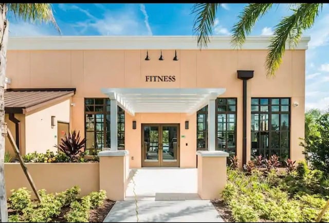 1870 Sawyer Palm Pl Unit 1870, Kissimmee, FL 34747 - view of exterior entry with stucco siding and french doors