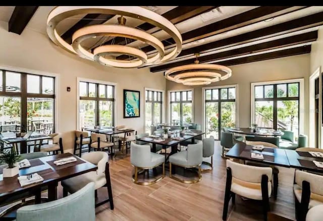 1870 Sawyer Palm Pl Unit 1870, Kissimmee, FL 34747 - dining area featuring beam ceiling, wood finished floors, and a chandelier