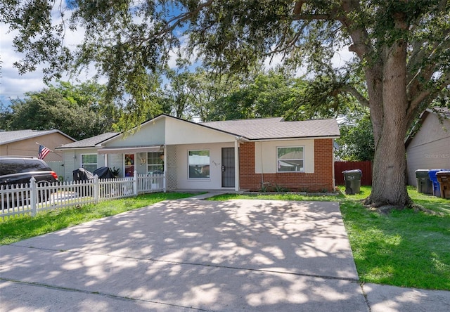 2531 Coral Ave, Kissimmee, FL 34741 - single story home with brick siding, covered porch, and a fenced front yard