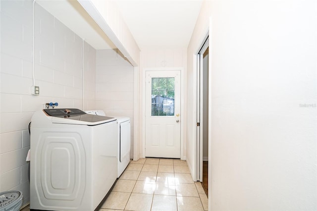 2531 Coral Ave, Kissimmee, FL 34741 - washroom with washing machine and clothes dryer and light tile patterned flooring