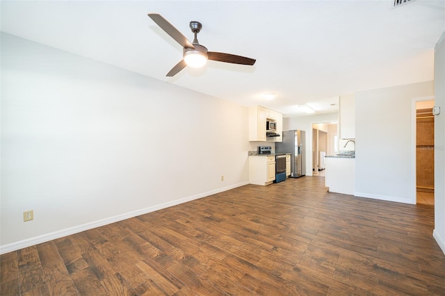 2531 Coral Ave, Kissimmee, FL 34741 - unfurnished living room with dark wood-style flooring and a ceiling fan