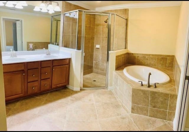 20080 Ragazza Cir Unit 102, Venice, FL 34293 - full bathroom with crown molding, double vanity, a garden tub, a stall shower, and tile patterned flooring