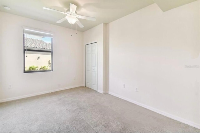 20080 Ragazza Cir Unit 102, Venice, FL 34293 - carpeted empty room featuring a smoke detector and a ceiling fan