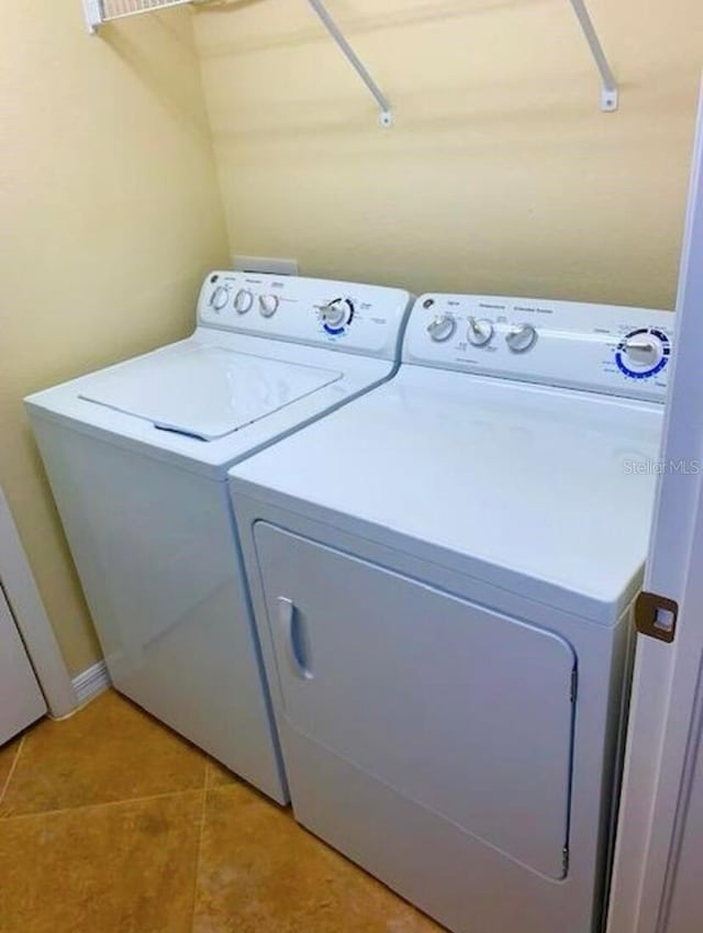 20080 Ragazza Cir Unit 102, Venice, FL 34293 - laundry room with independent washer and dryer and light tile patterned flooring