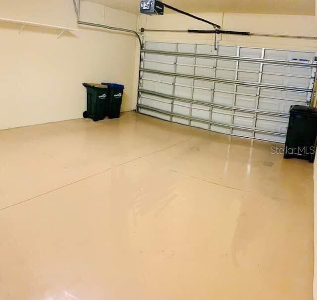 20080 Ragazza Cir Unit 102, Venice, FL 34293 - garage featuring a garage door opener