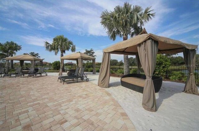 20080 Ragazza Cir Unit 102, Venice, FL 34293 - view of patio / terrace featuring a gazebo