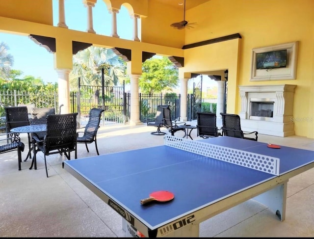 20080 Ragazza Cir Unit 102, Venice, FL 34293 - view of patio featuring exterior fireplace, ceiling fan, and outdoor dining space
