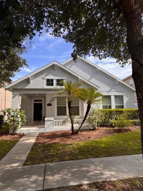 14548 Black Cherry Trl, Winter Garden, FL 34787 - bungalow featuring covered porch and stucco siding