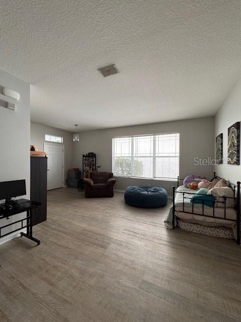14548 Black Cherry Trl, Winter Garden, FL 34787 - living area with wood finished floors and a textured ceiling