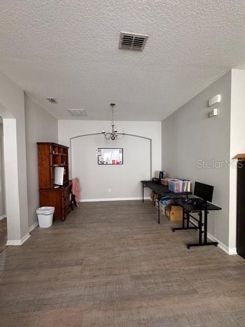 14548 Black Cherry Trl, Winter Garden, FL 34787 - dining room with wood finished floors, a chandelier, and a textured ceiling