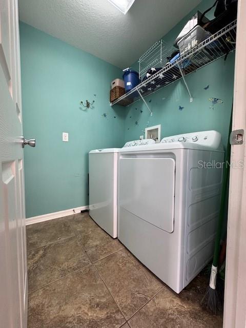 14548 Black Cherry Trl, Winter Garden, FL 34787 - laundry room with washer and dryer and baseboards