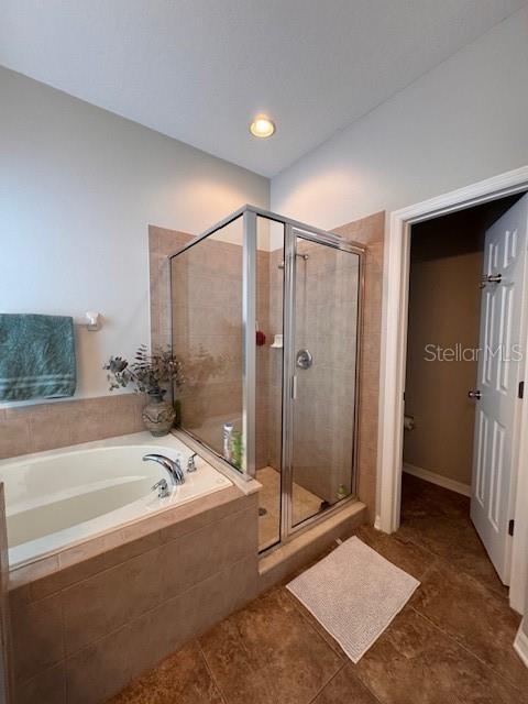 14548 Black Cherry Trl, Winter Garden, FL 34787 - full bath with a bath, a shower stall, and tile patterned flooring