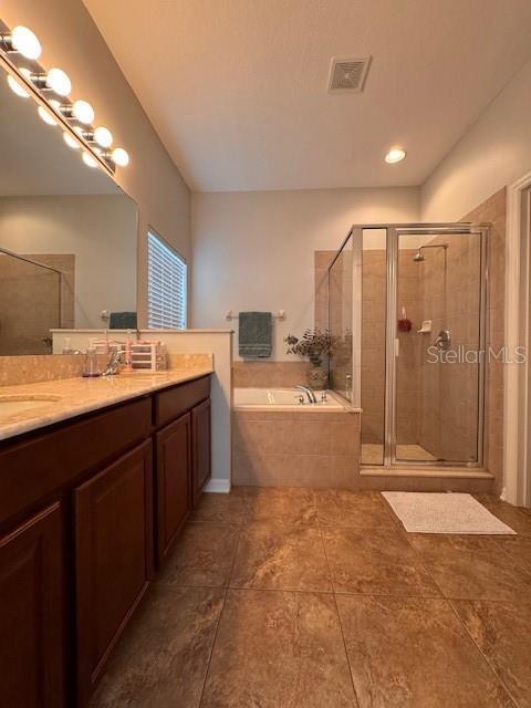 14548 Black Cherry Trl, Winter Garden, FL 34787 - bathroom with a garden tub, vanity, a shower stall, and tile patterned flooring