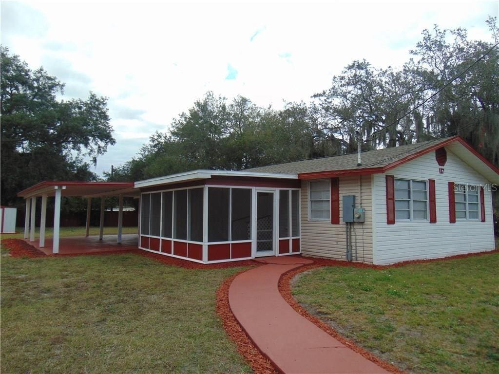 117 Idaho Ave, Lakeland, FL 33801 - rear view of house featuring a sunroom and a yard