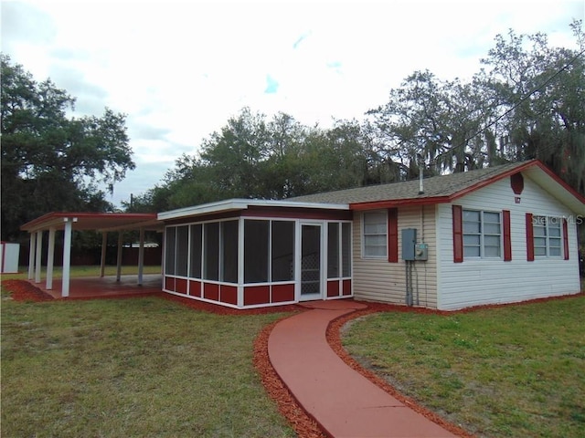 117 Idaho Ave, Lakeland, FL 33801 - rear view of house featuring a sunroom and a yard