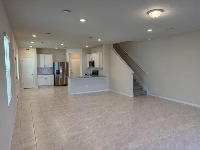 2602 Buena View Rd, Kissimmee, FL 34746 - unfurnished living room with stairs, recessed lighting, and light tile patterned floors