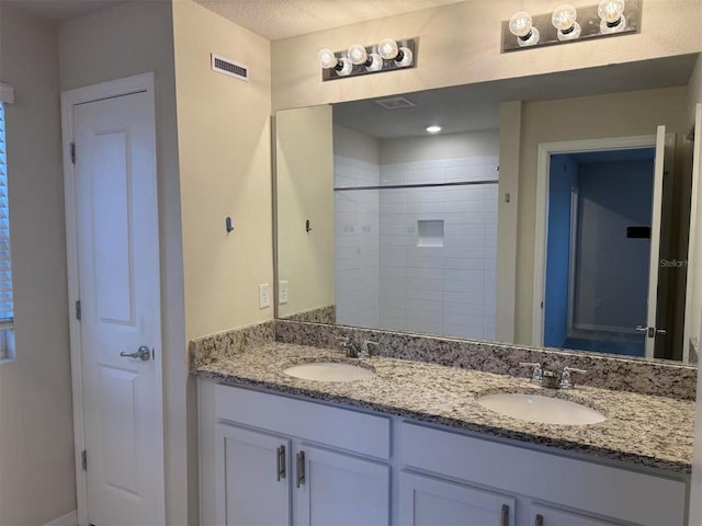 2602 Buena View Rd, Kissimmee, FL 34746 - bathroom featuring double vanity and a tile shower