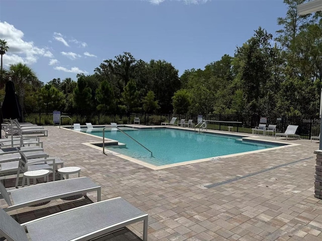 2602 Buena View Rd, Kissimmee, FL 34746 - community pool featuring a patio area and view of scattered trees