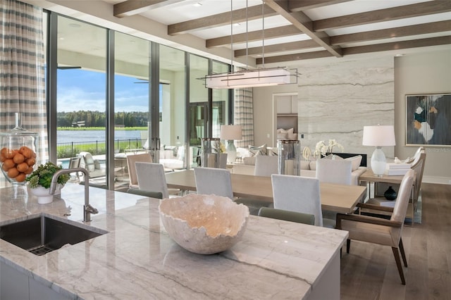 4162 Grande Brick Loop Unit 27, Orlando, FL 32837 - dining space with wood finished floors, beam ceiling, and a water view