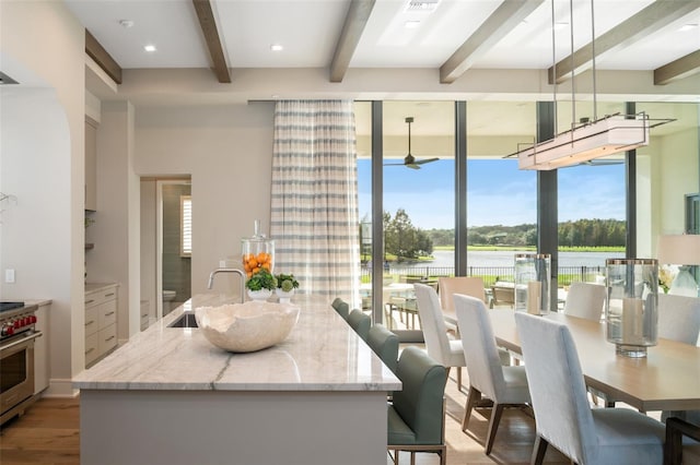4162 Grande Brick Loop Unit 27, Orlando, FL 32837 - dining area featuring beamed ceiling, a water view, and light wood finished floors