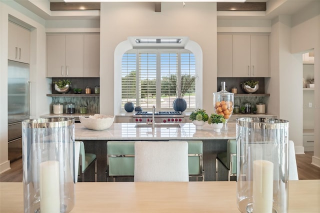 4162 Grande Brick Loop Unit 27, Orlando, FL 32837 - kitchen featuring decorative backsplash, stainless steel built in refrigerator, light stone countertops, and a kitchen breakfast bar