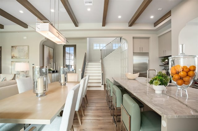 4162 Grande Brick Loop Unit 27, Orlando, FL 32837 - dining area featuring beamed ceiling, light wood-style floors, stairway, and recessed lighting