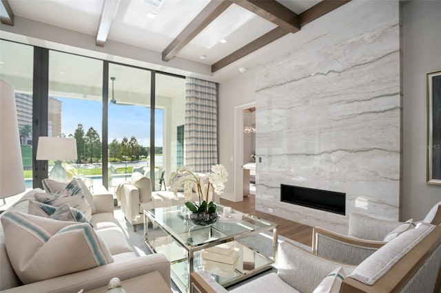 4162 Grande Brick Loop Unit 27, Orlando, FL 32837 - living area with a high end fireplace, beam ceiling, wood finished floors, and a water view