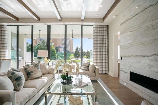 4162 Grande Brick Loop Unit 27, Orlando, FL 32837 - living area featuring beam ceiling, wood finished floors, floor to ceiling windows, and a fireplace