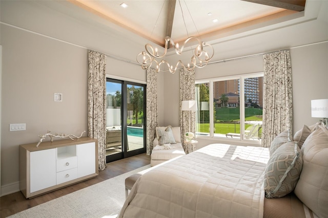 4162 Grande Brick Loop Unit 27, Orlando, FL 32837 - bedroom with access to outside, a tray ceiling, a chandelier, and wood finished floors