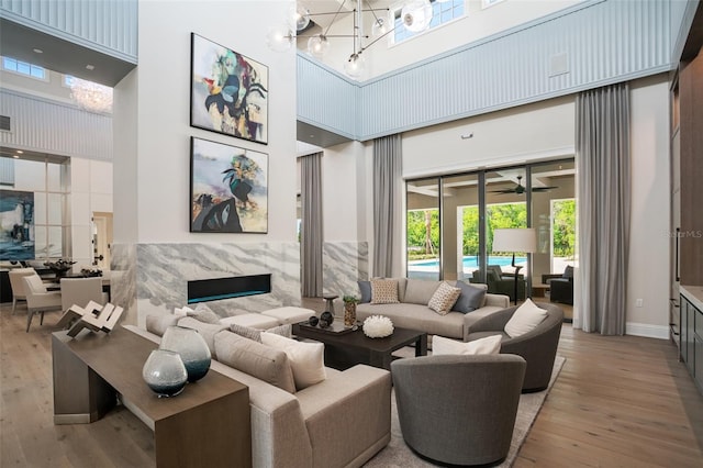 4162 Grande Brick Loop Unit 27, Orlando, FL 32837 - living area featuring a high ceiling, wood-type flooring, plenty of natural light, and a chandelier