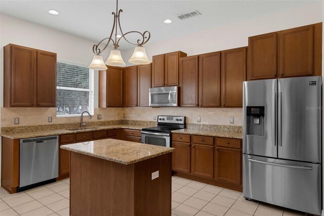 2534 Double Tree Pl, Oviedo, FL 32766 - kitchen featuring stainless steel appliances, light tile patterned floors, tasteful backsplash, hanging light fixtures, and recessed lighting