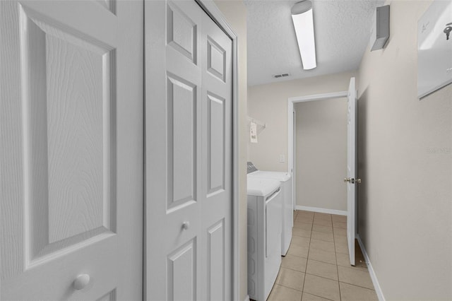 2534 Double Tree Pl, Oviedo, FL 32766 - laundry room with washer and dryer, light tile patterned flooring, and a textured ceiling