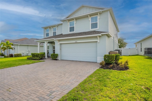 3840 Fescue St, Clermont, FL 34714 - view of front of home with decorative driveway, an attached garage, board and batten siding, and roof with shingles
