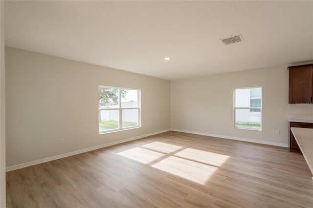 3840 Fescue St, Clermont, FL 34714 - unfurnished living room with light wood-style floors and recessed lighting