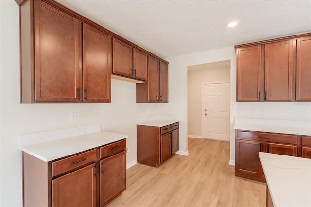 3840 Fescue St, Clermont, FL 34714 - kitchen featuring light wood-style flooring, recessed lighting, light countertops, and brown cabinets