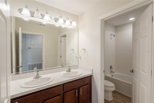 3840 Fescue St, Clermont, FL 34714 - full bath with double vanity, bathing tub / shower combination, and wood finished floors