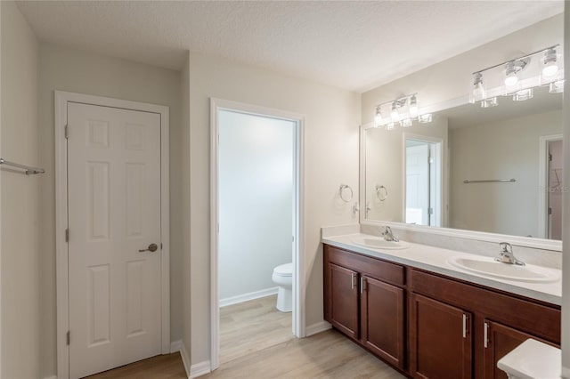 3840 Fescue St, Clermont, FL 34714 - bathroom with double vanity, wood finished floors, and a closet